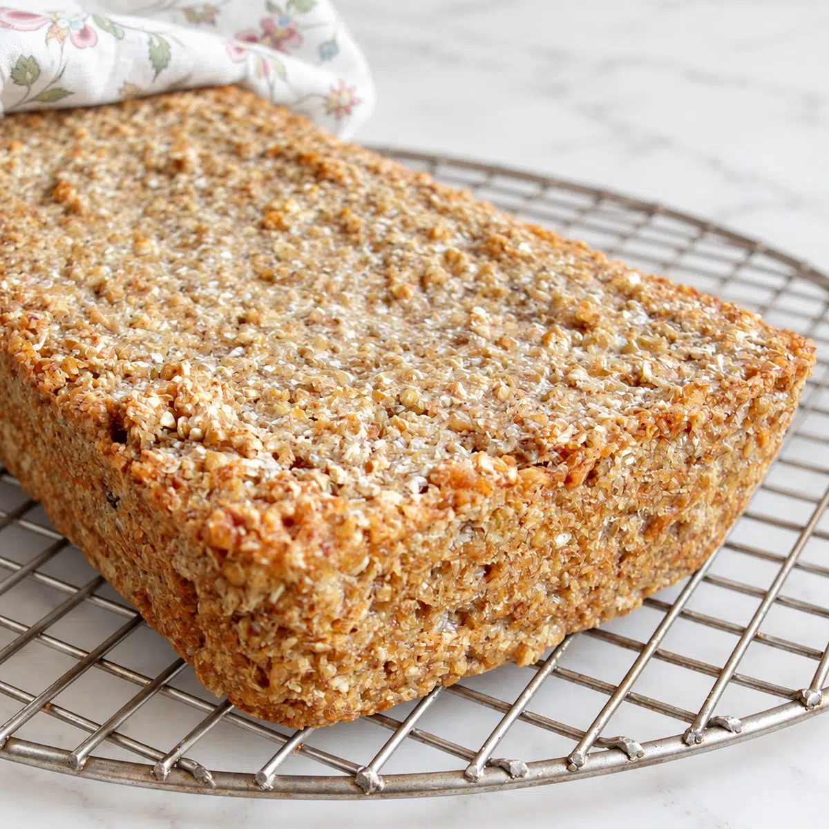 loaf of 1-ingredient buckwheat bread on a cooling rack