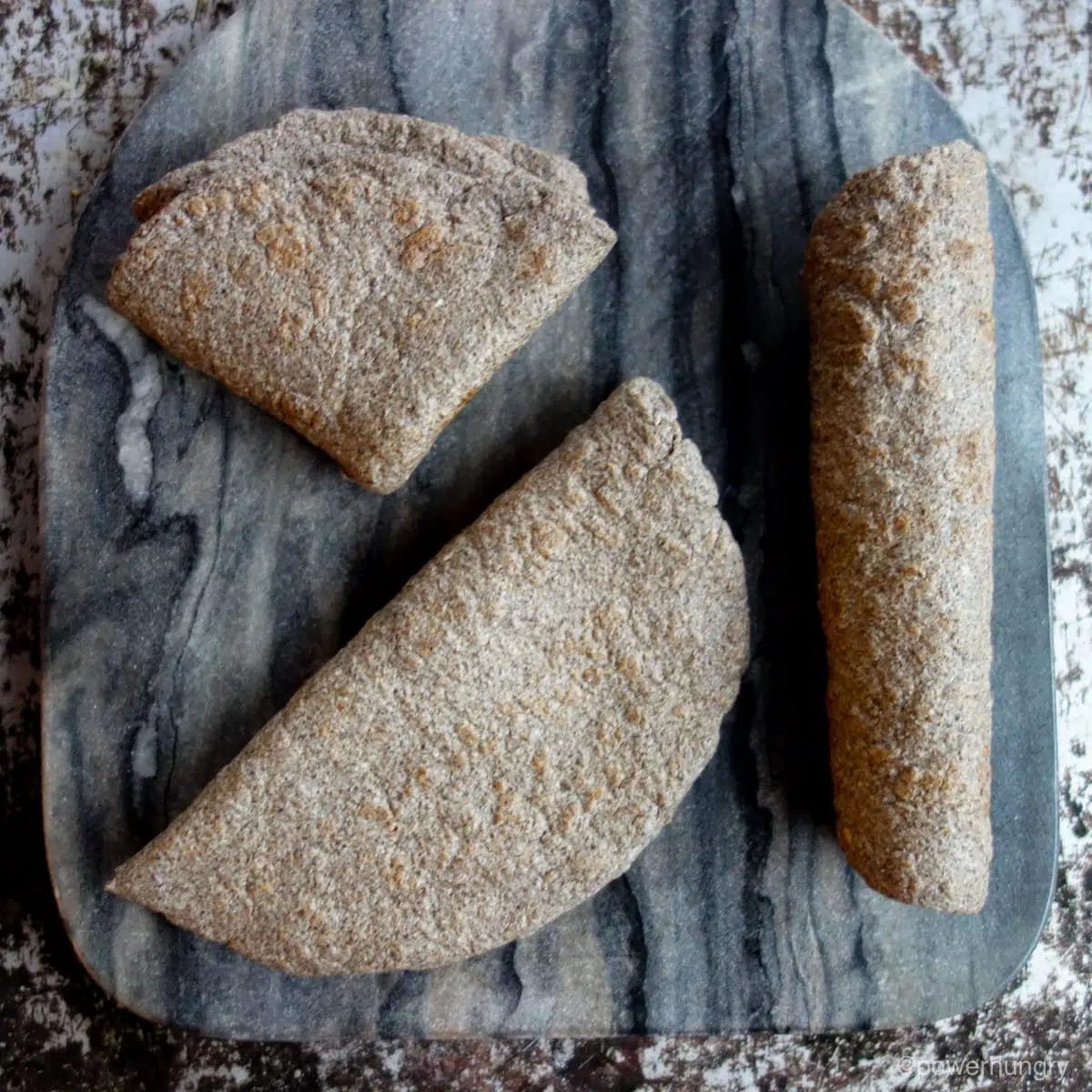 photo of three chia flatbreads, folded, rolled and quartered
