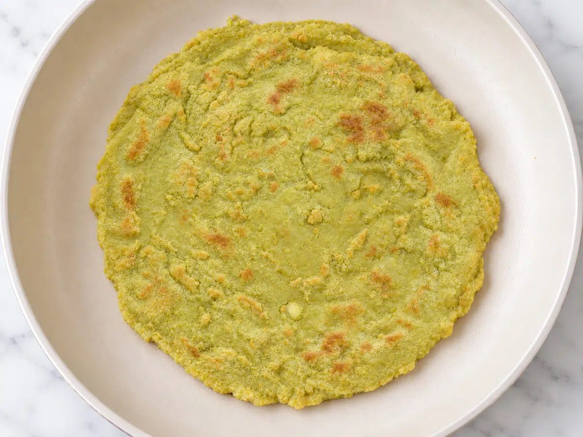 cooked and flipped 1-ingredient split pea flatbread in a skillet