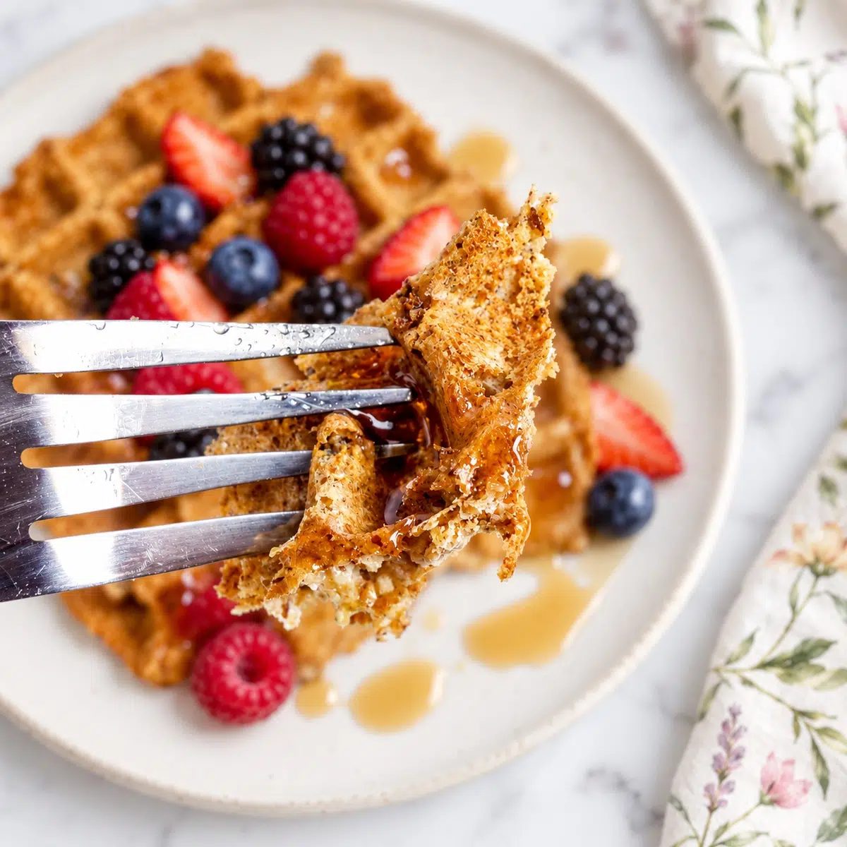 close-up of a fork with some flaxseed waffle on it