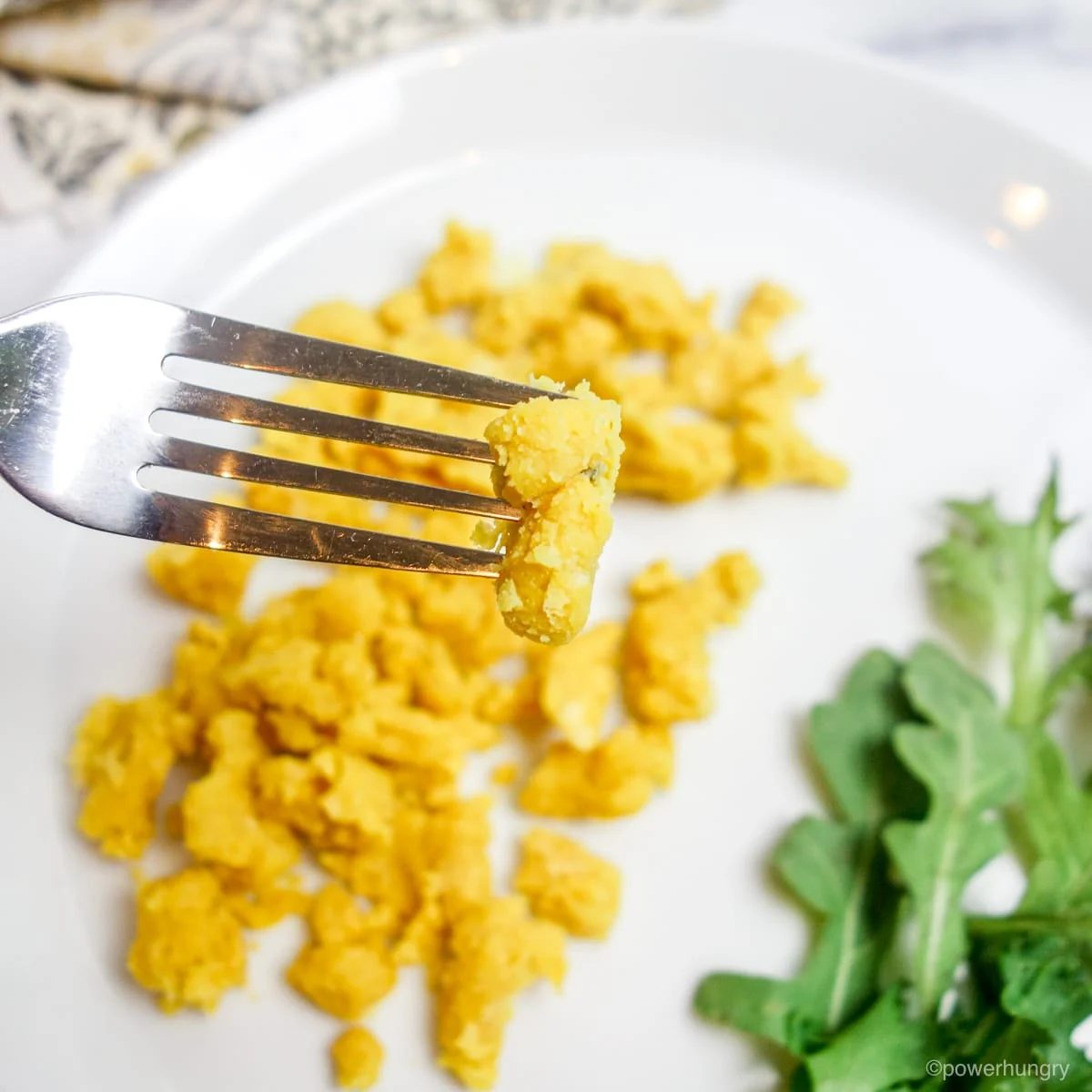 close up of a forkful of vegan scrambled eggs