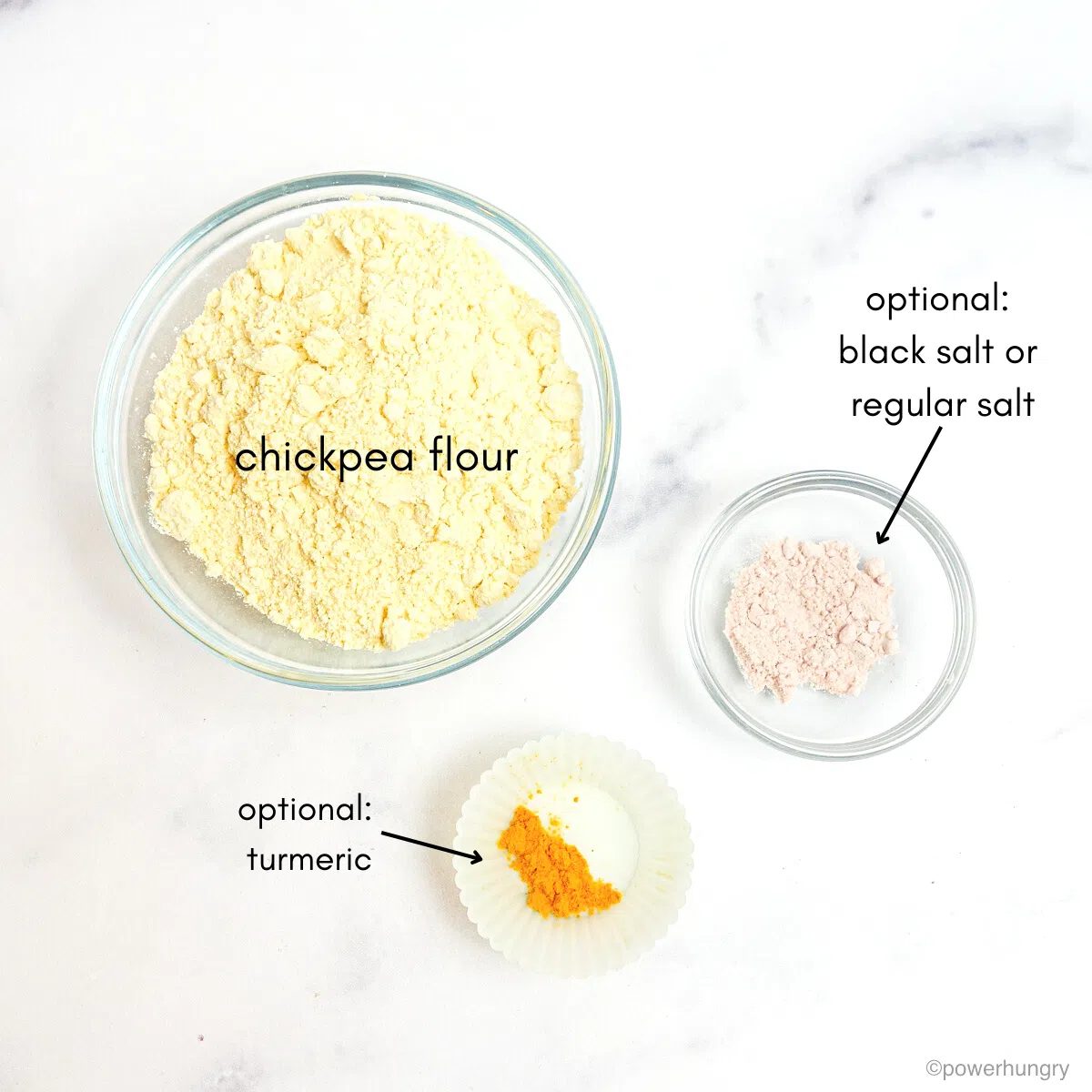 ingredients for vegan scramble in glass bowls atop a marble counter