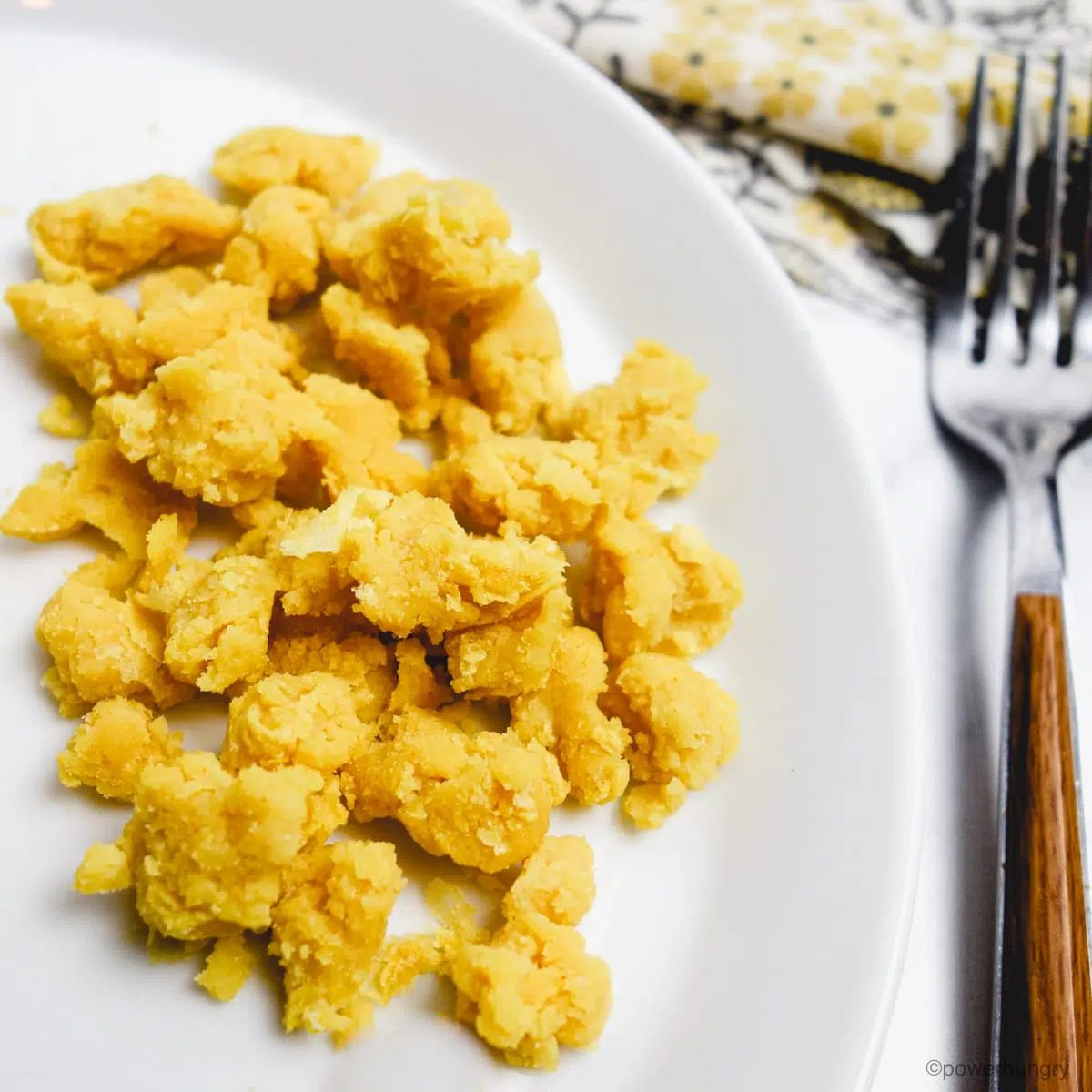 plant based vegan scramble on a white plate with a fork alongside