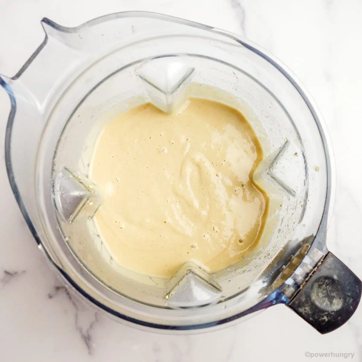 blender filled with some of the batter for millet banana bread