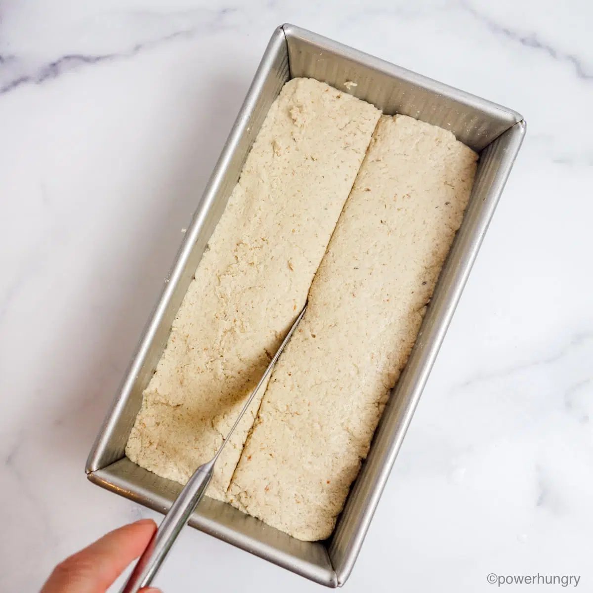 sorghum bread dough with a slaw being cut across the top