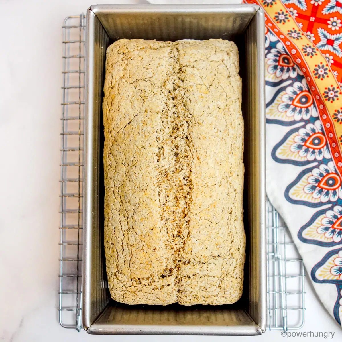 loaf of sorghum bread on a metal cooling rack