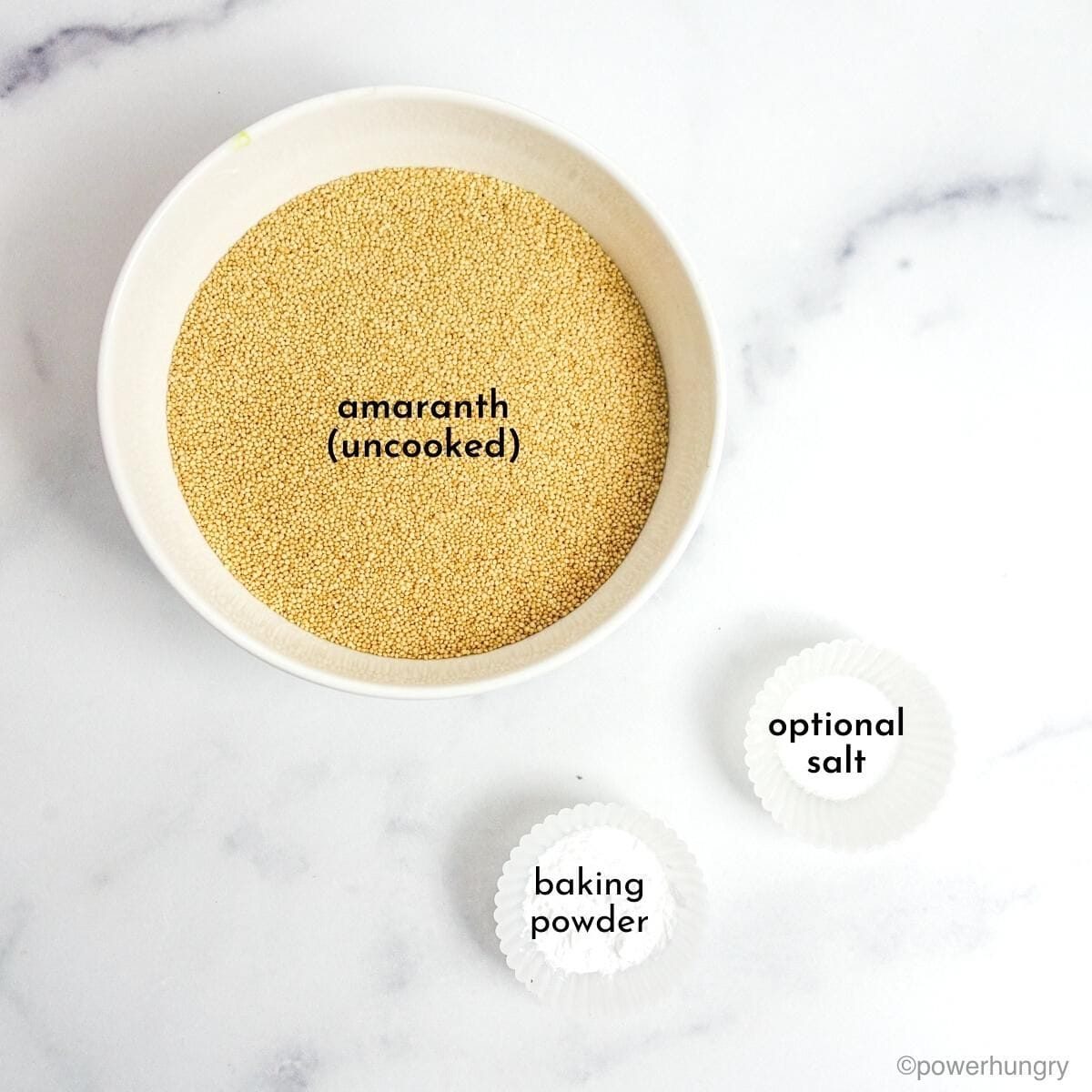overhead shot of the ingredient for amaranth flatbread in small bowls on a white marble surface