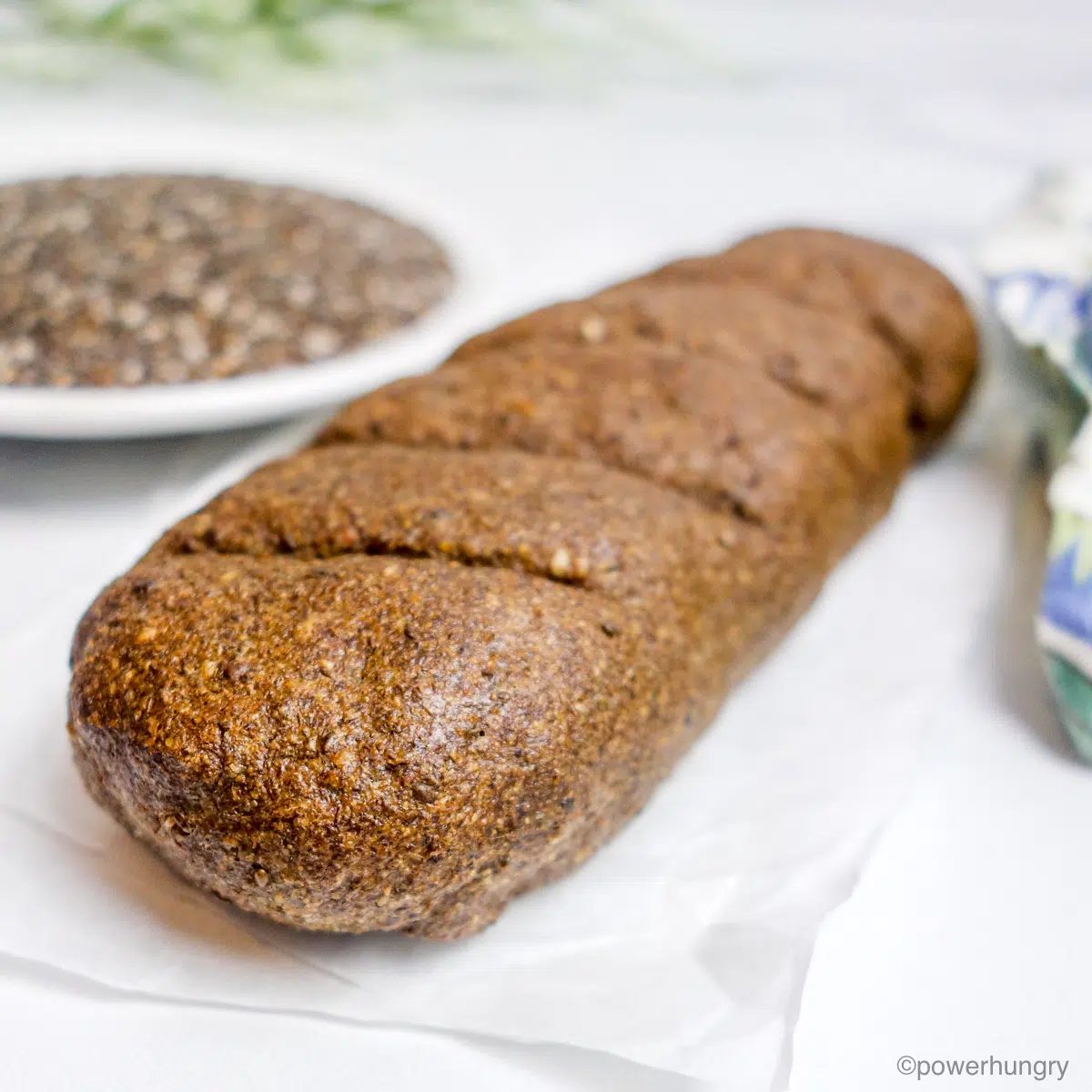 loaf of 2-ingredinet chia seed bread and a bowl of chia seeds