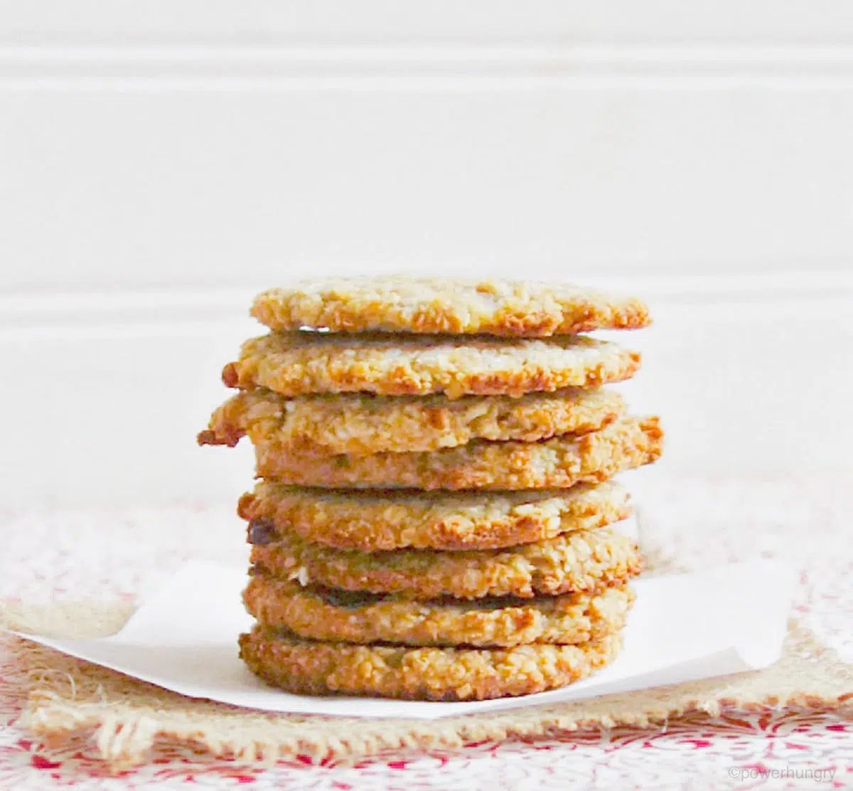 stack of coconut banana cookies on a red and white tabletop