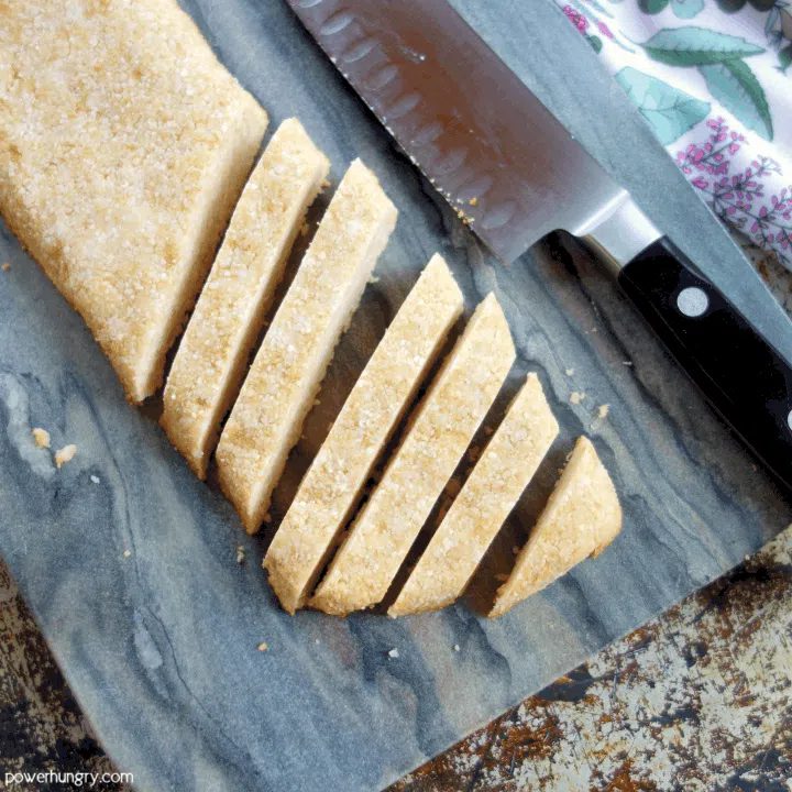 loaf of baked coconut flour biscotti, partially cut into individual pieces