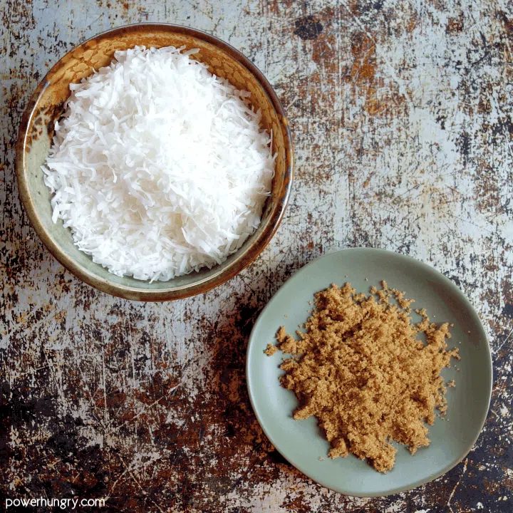 The 2 ingredients for coconut biscotti, unsweetened coconut flakes an coconut sugar