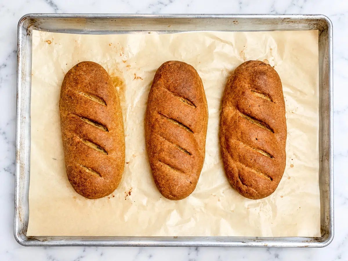 baked loaves of flaxseed bread on baking sheet