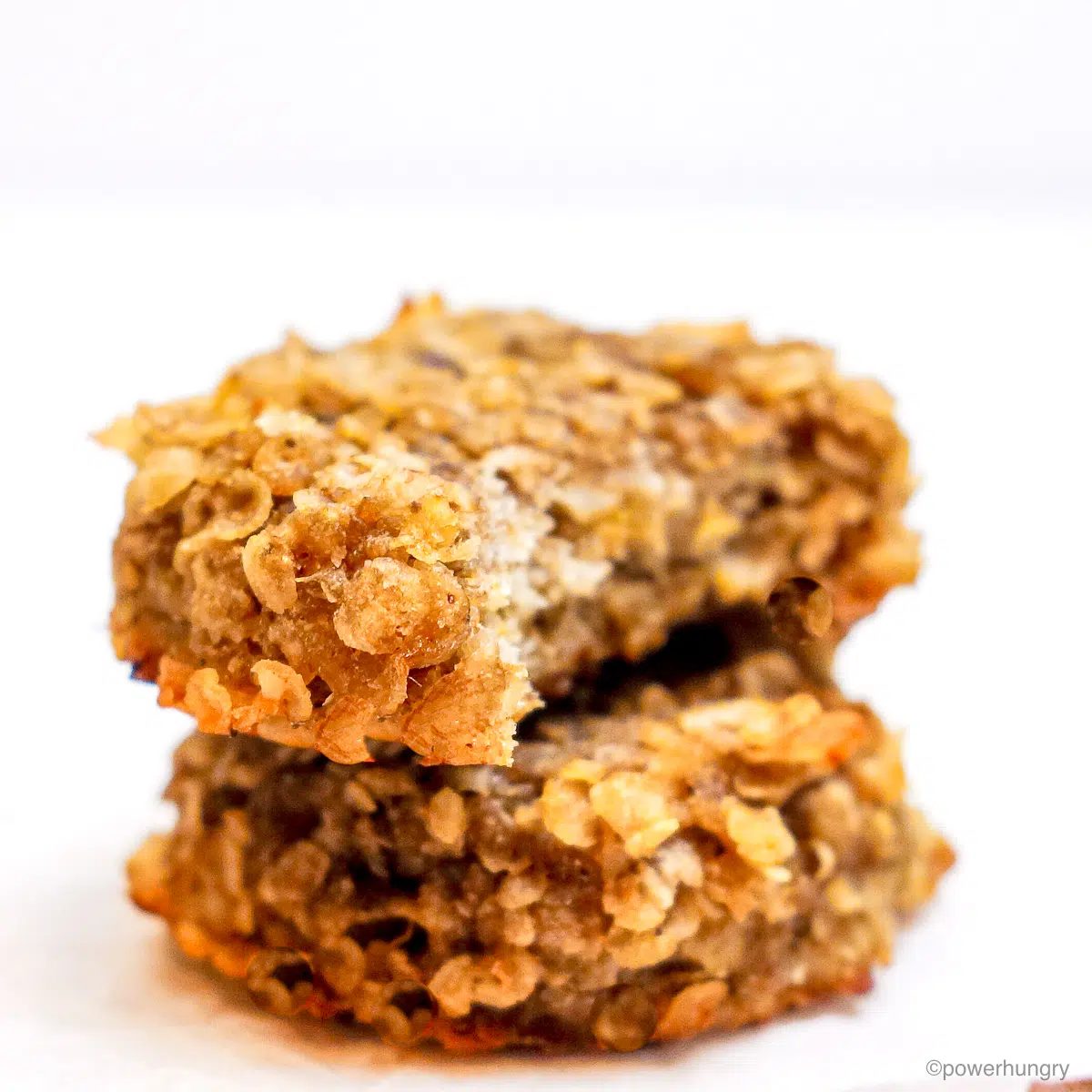 stack of two banana millet cookies, one with a bite taken out of it