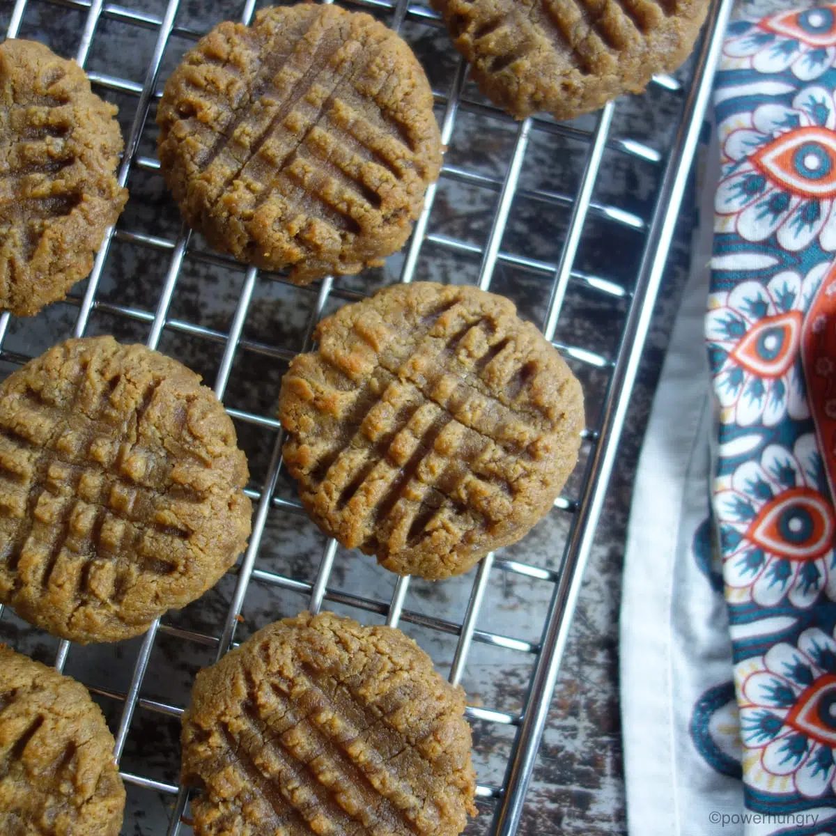 cookies cooling on a cooling rack with a colorful napkin alongside