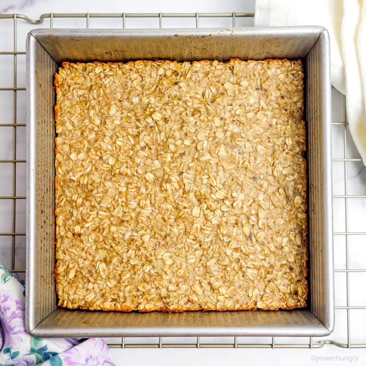 baked banana oat bars in a square pan on a cooling rack