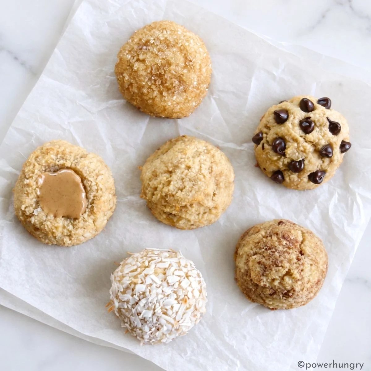a crumpled piece of white parchment paper showing several plain variations for banana almond flour cookies