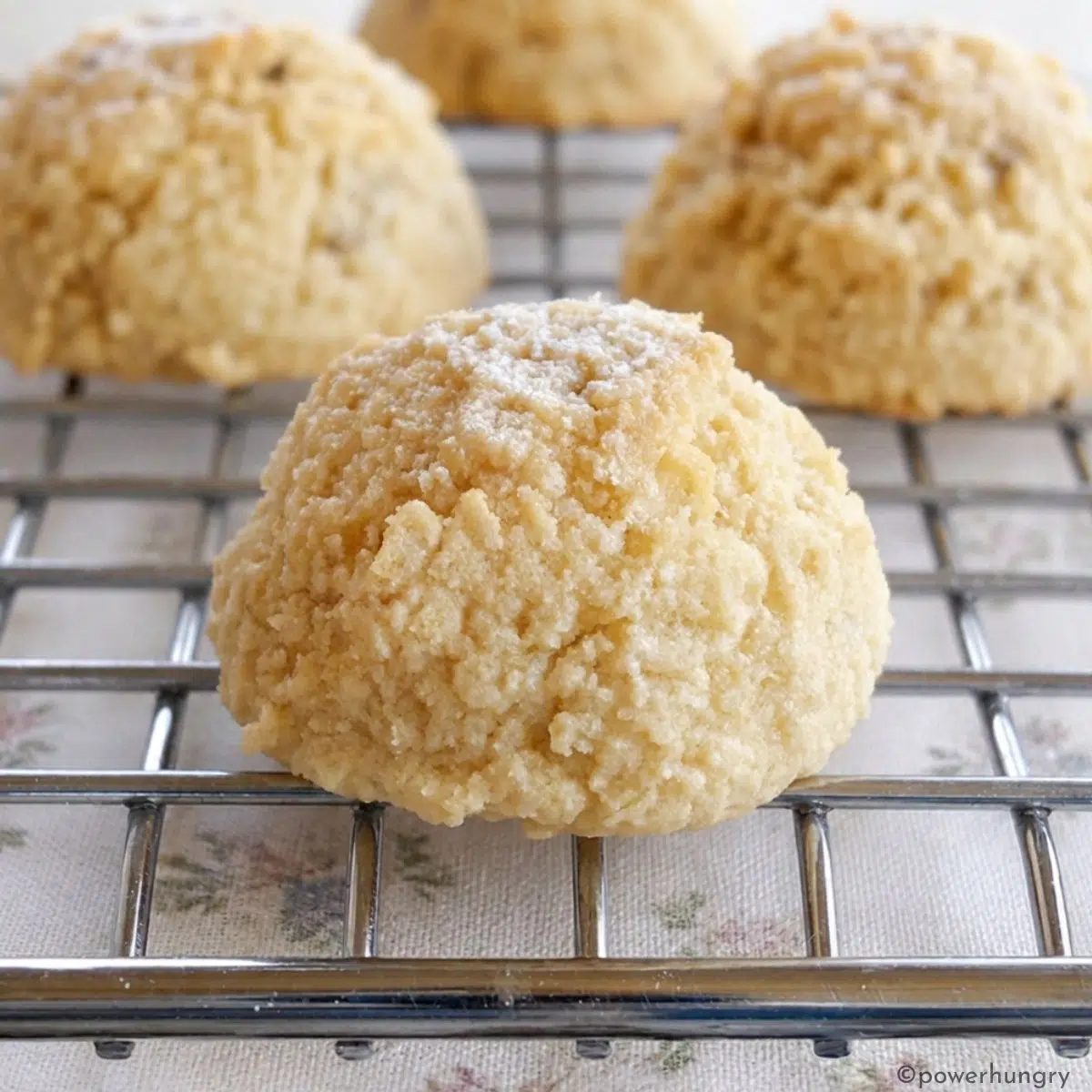 almond flour cookies, sweetened with very ripe bananas, on a silver cooling rack with a linen napkin underneath