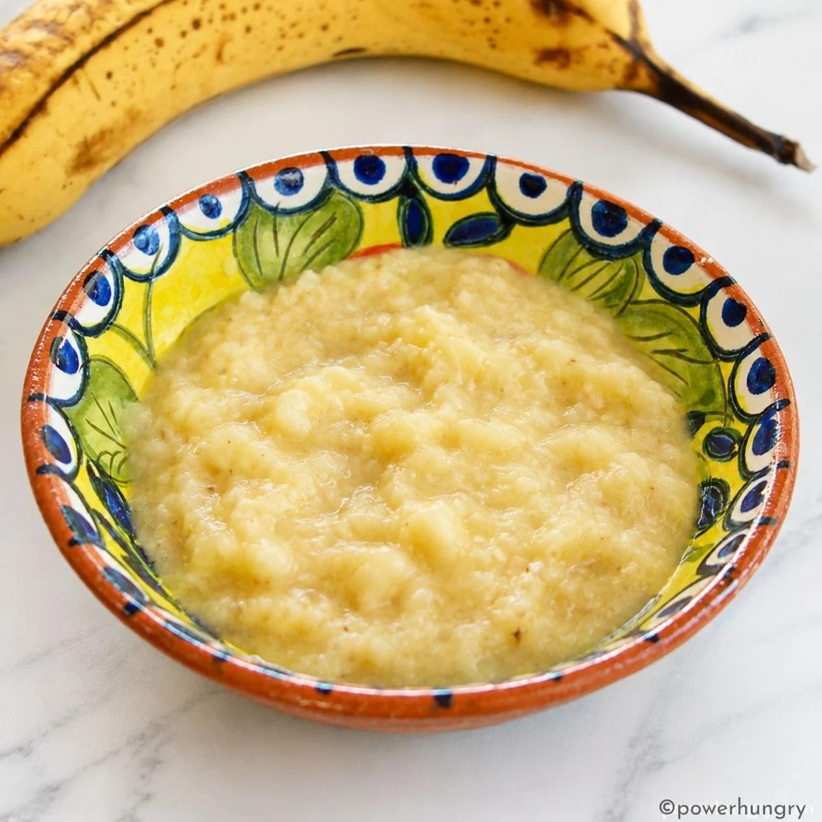 mashed very ripe banana in a colorful bowl