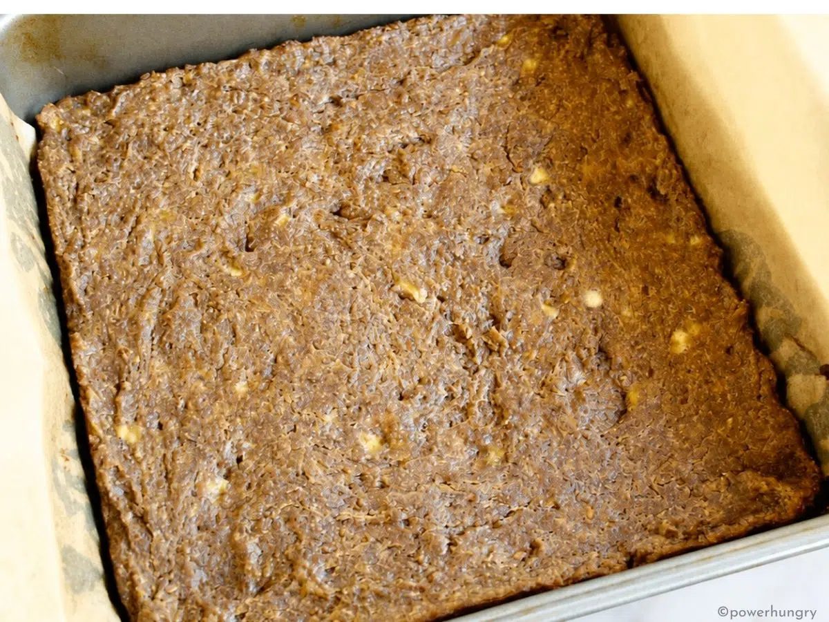 Baked banana flax bars cooling in a parchment-lined pan