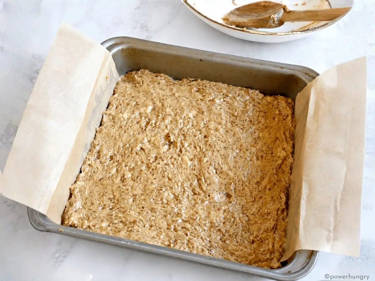Banana flax batter spread in an 8-inch square pan