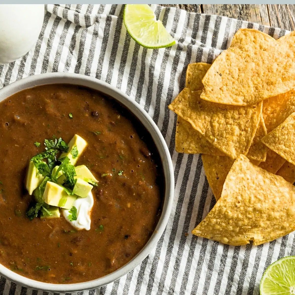 black bean pumpkin soup with some tortilla chips alongside