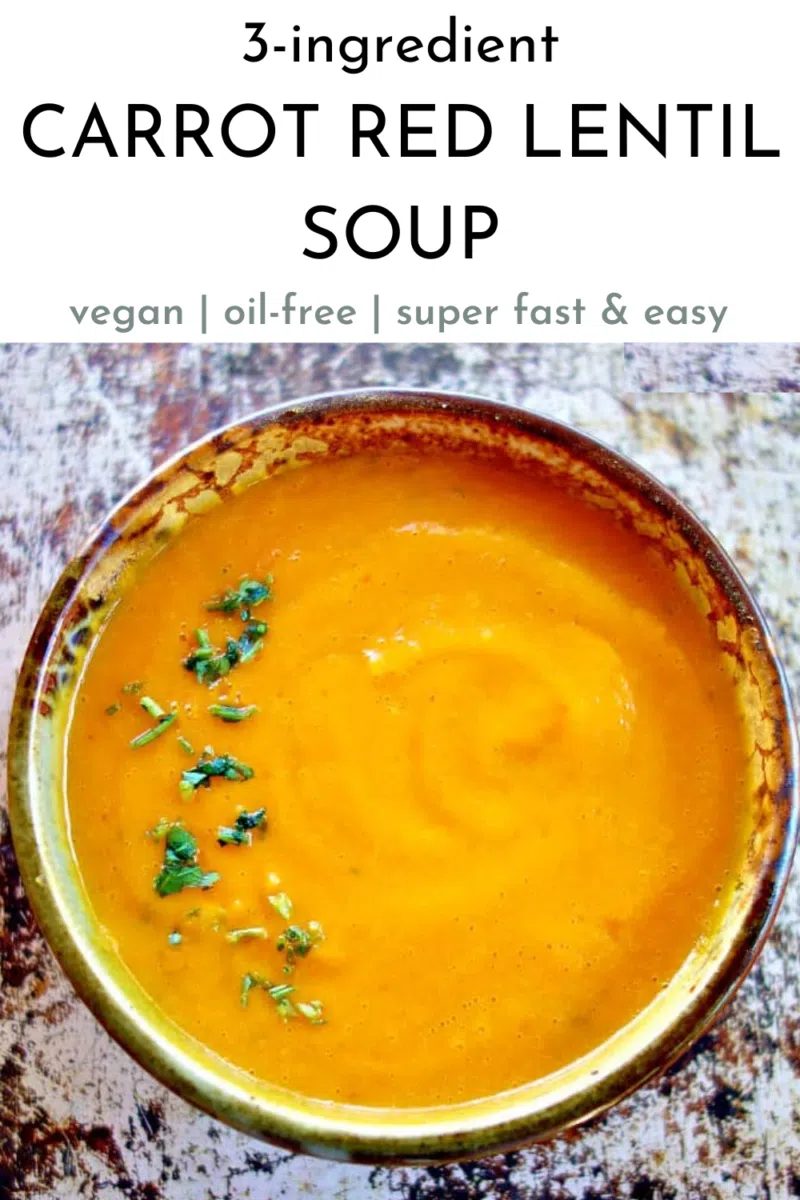 overhead shot of carrot red lentil soup in an earthenware bowl
