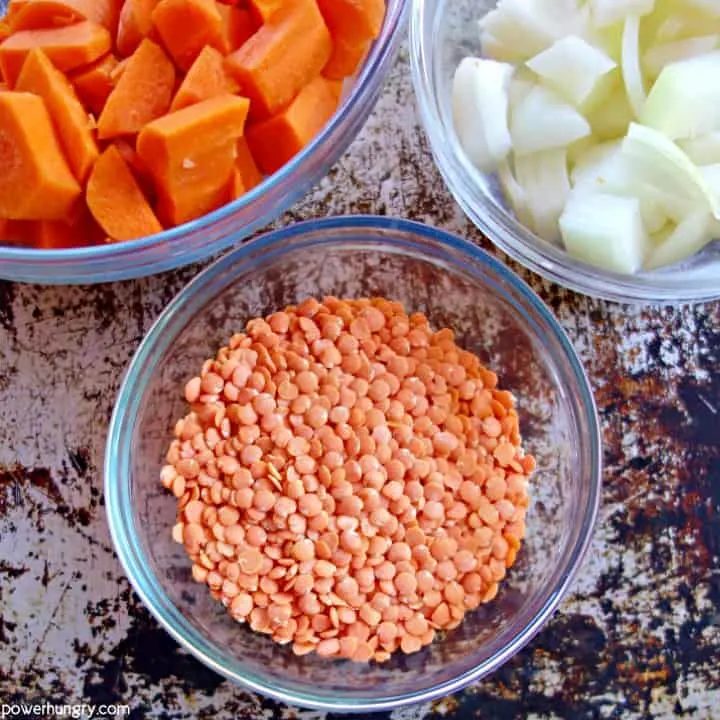 overhead shot of the three ingredients needed to make carrot red lentil soup