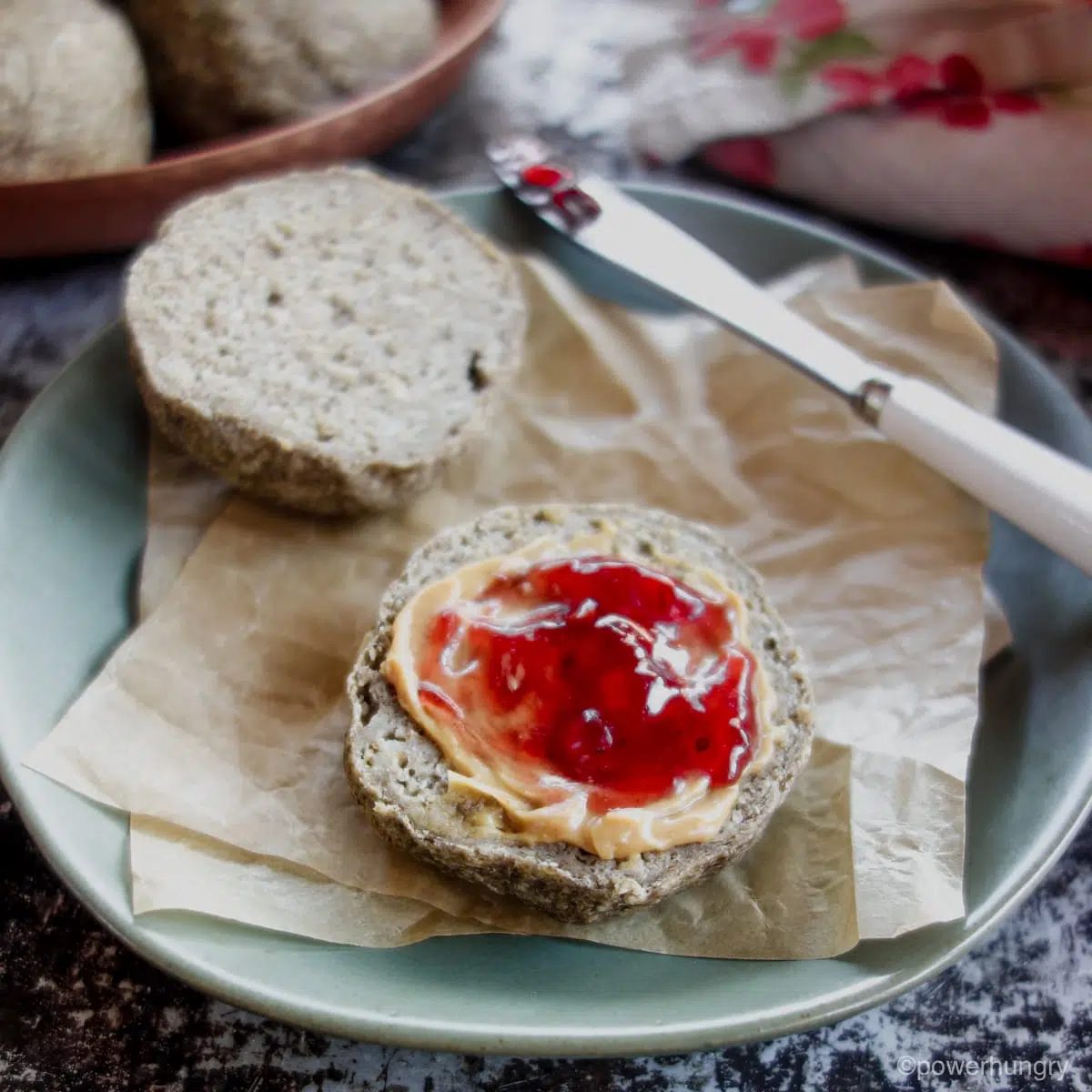 an oat and chia roll , split, and spread with cashew butter and jam.