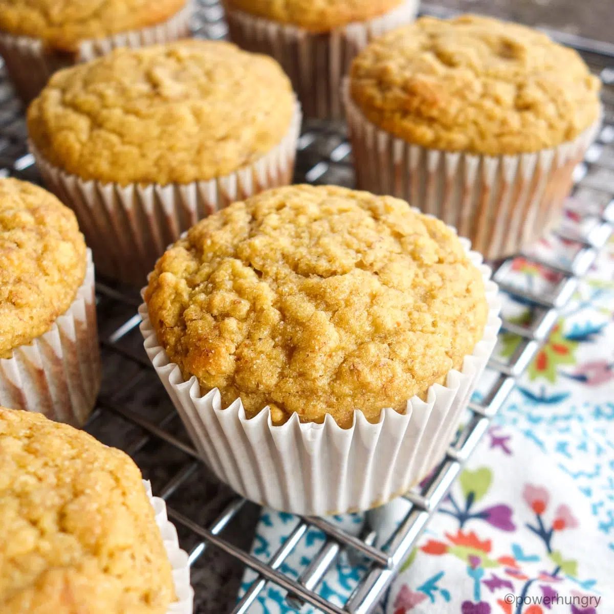 muffins on a cooling rack with a napkin alongside.