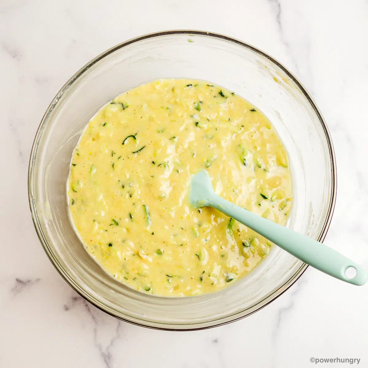 glass bowl filled with 3 ingredient vegan zucchini muffin batter