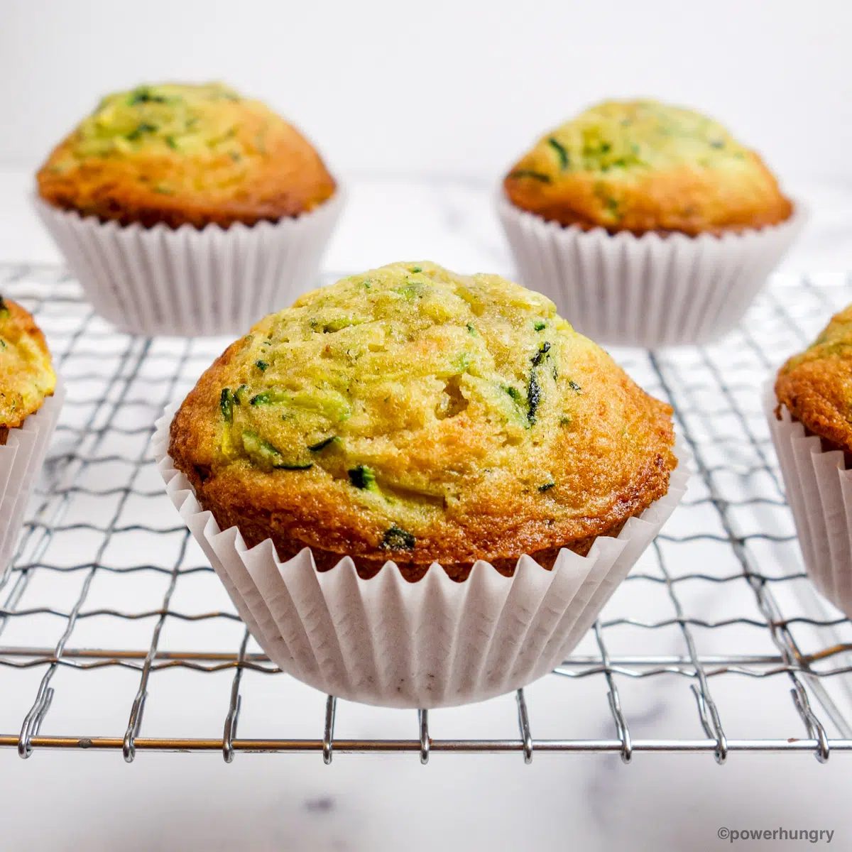 3 ingredient vegan zucchini muffins cooling on a cooling rack