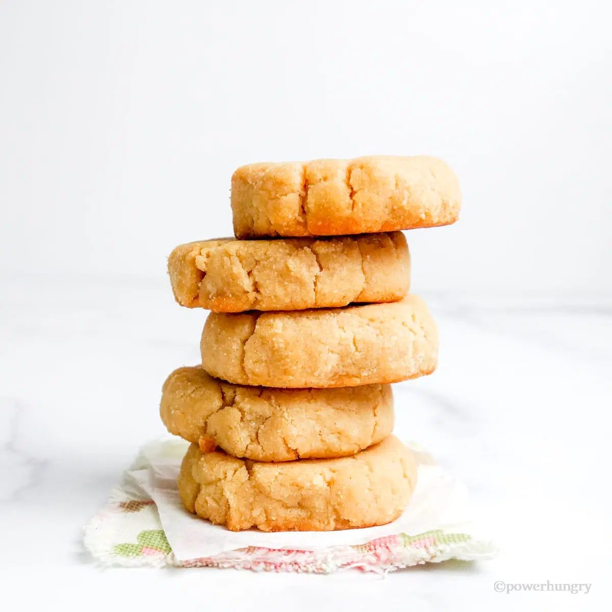 a stack of 5 coconut flour shortbread on a flral napkin