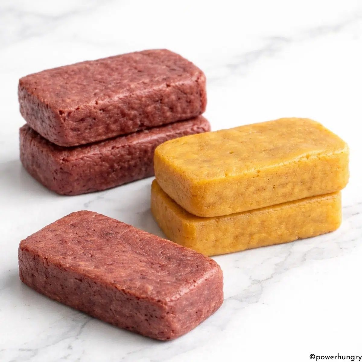 stacks of apricot and cherry 3 ingredient vegan protein bars
