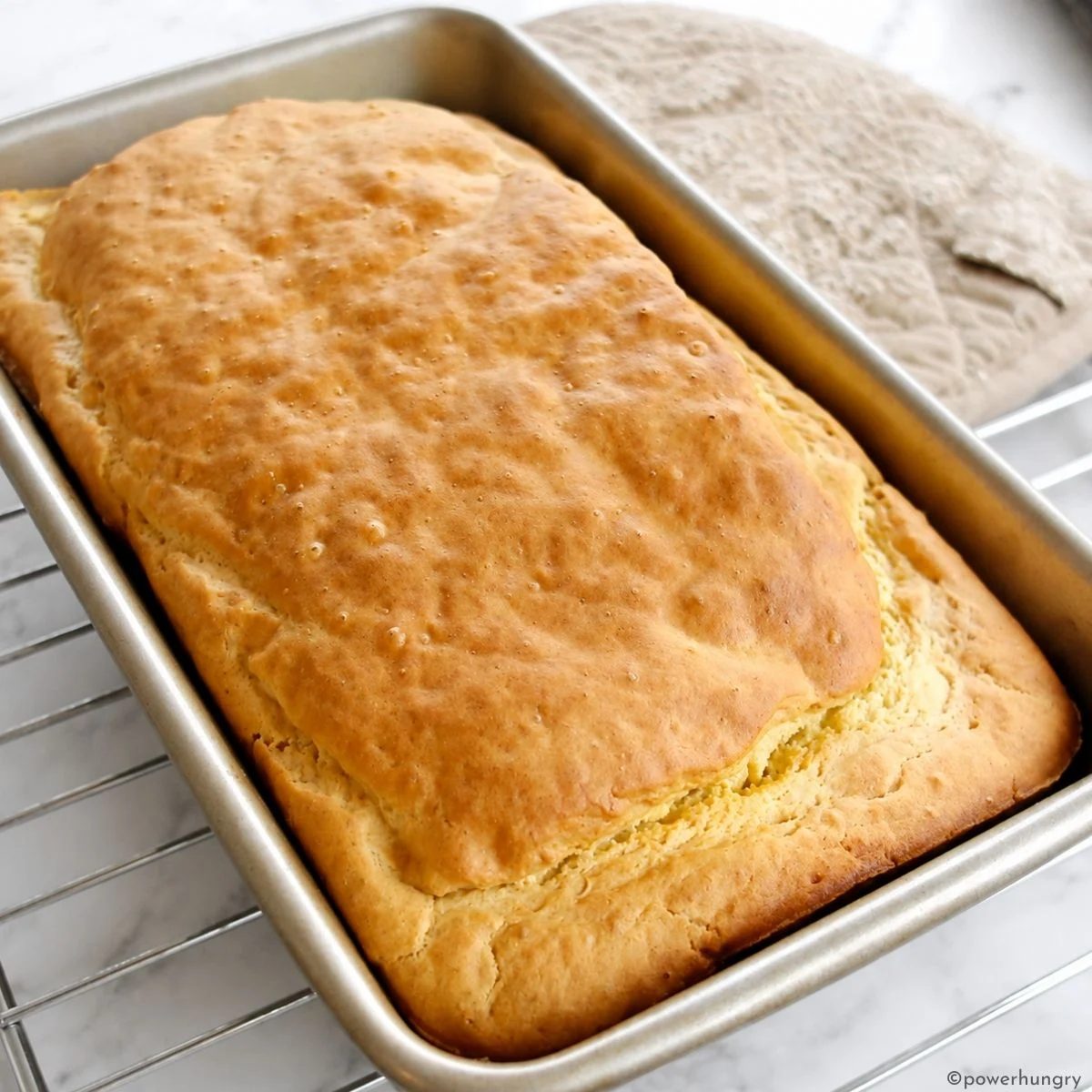 baked 3-ingredient chickpea flour bread on a silver cooling rack