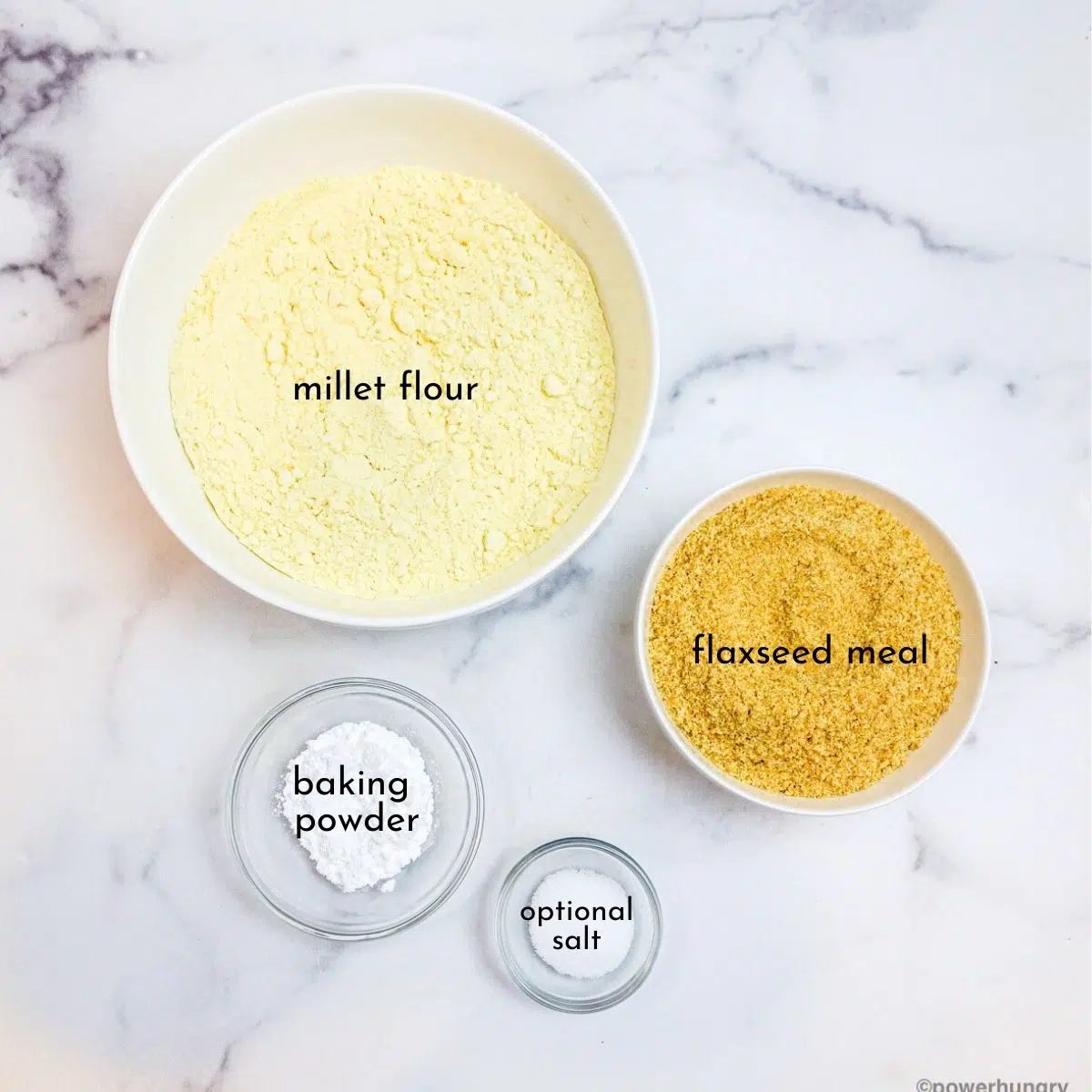 ingredients for millet flax bread in clear glass bowls