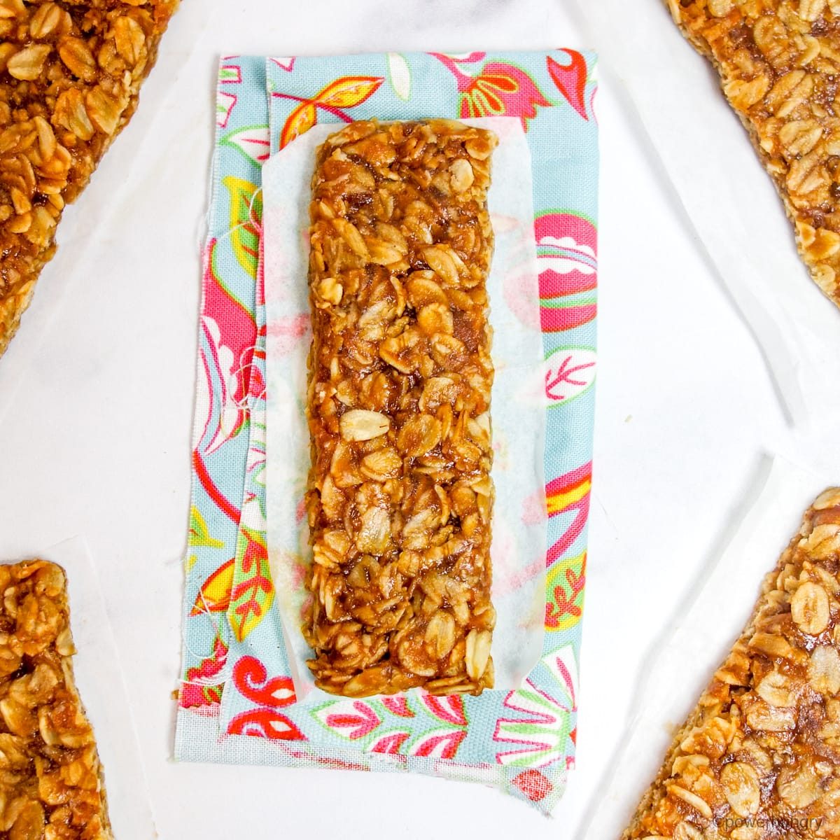 no bake granola bars on white parchment paper