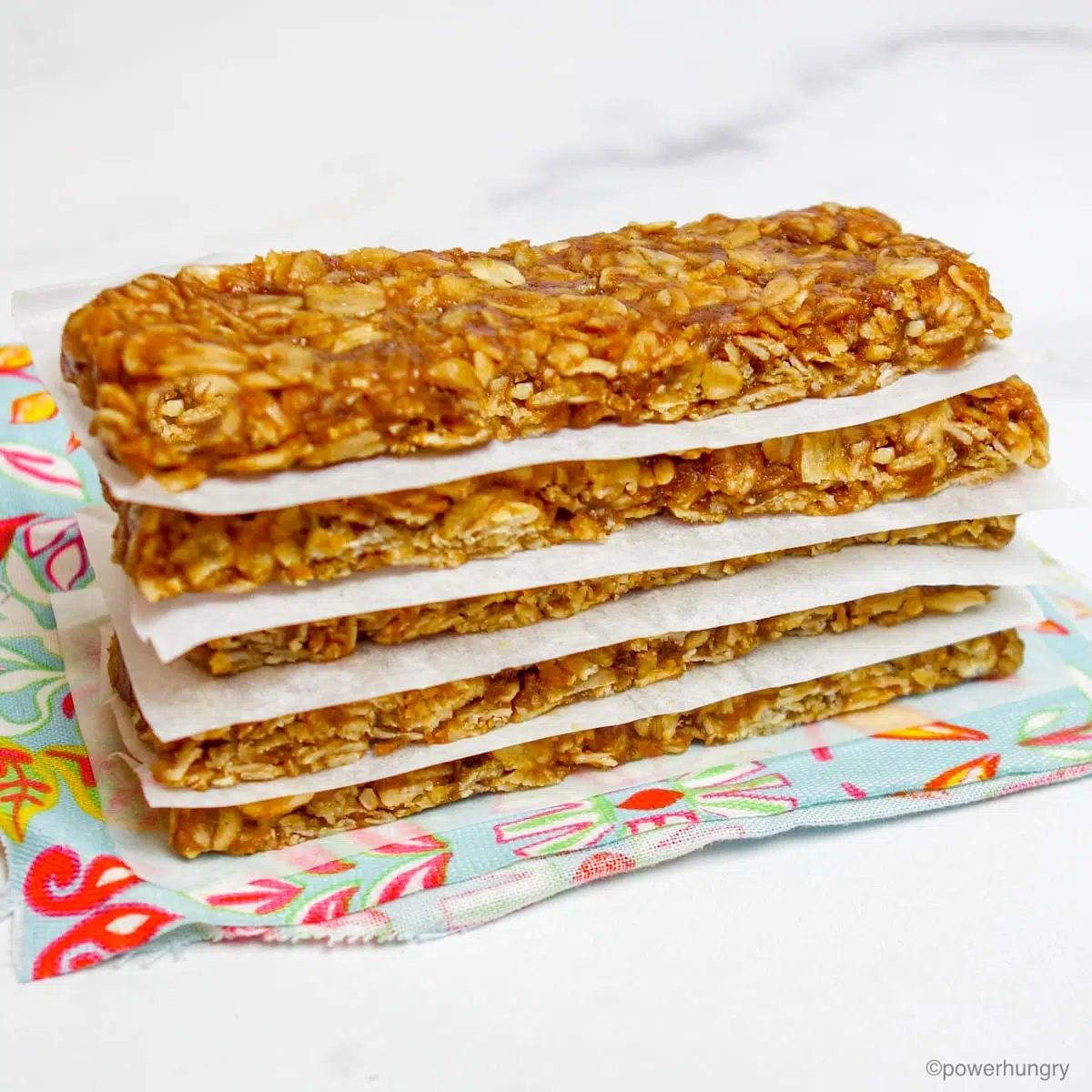a stack of 5 3-ingredient no-bake granola bars on a colorful napkin