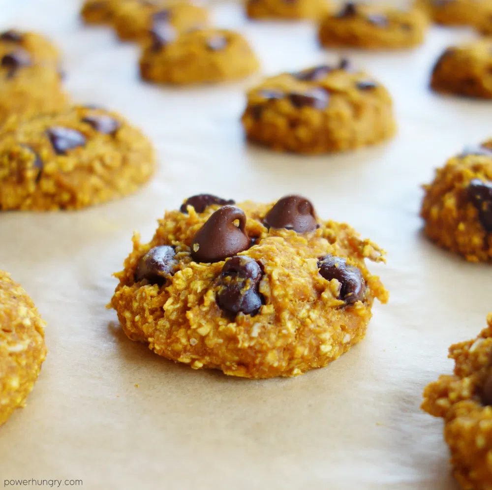 baked pumpkin oat cookies on a parchment paper lined baking sheet