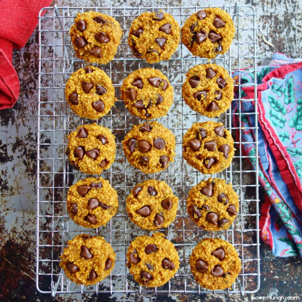 pumpkin oat cookies on a wire cooling rack with a blue and red napkin alongside