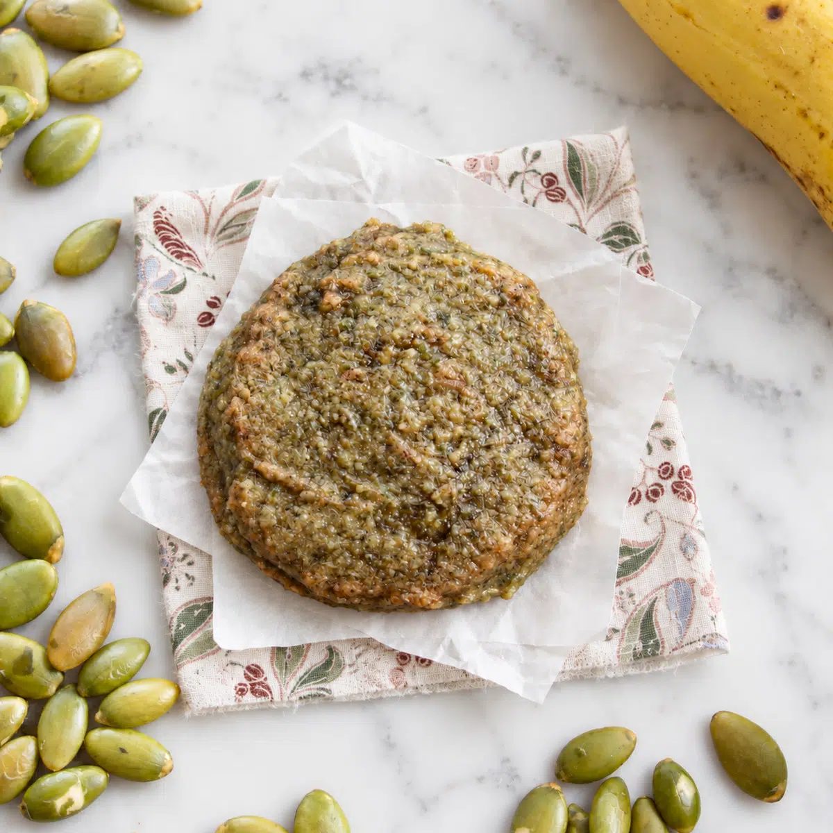 a single pumpkin seed flour banana cookie overhead image