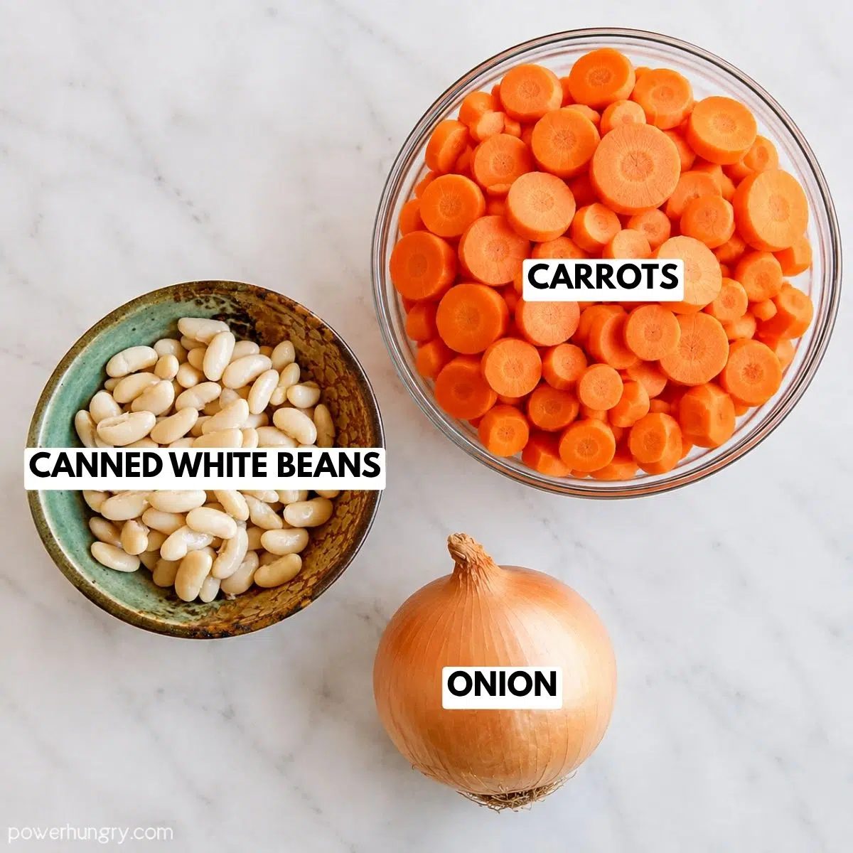 ingredients, on a white marble surface, in bowls, for 3-ingredient roasted carrot soup