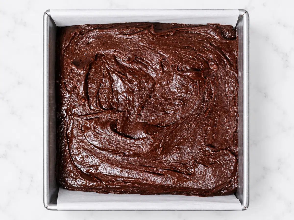 batter for sweet potato brownies in a lined pan