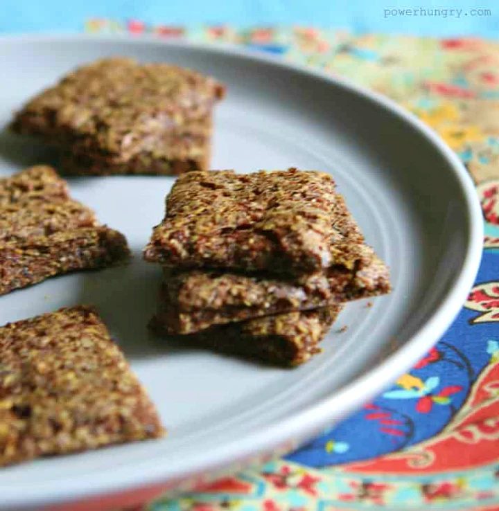 teff crackers on a grey pate atop a colorful napkin