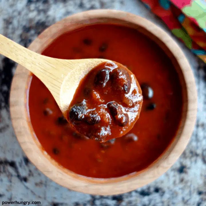 close-up of a wooden spoon with vegan enchilada soup