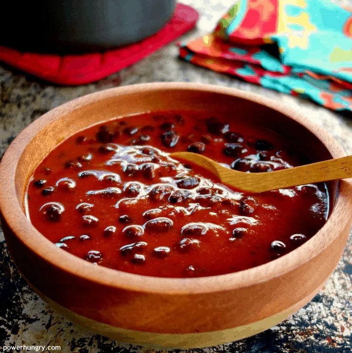 3-Ingredient Vegan Enchilada Soup in a wooden bowl with a wooden spoon