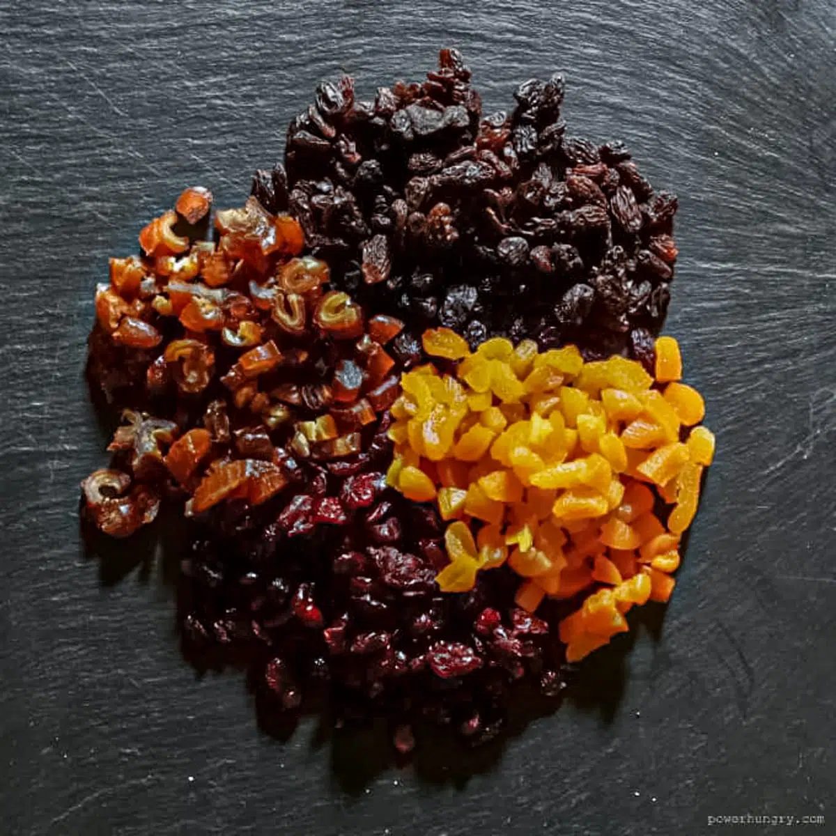 mixed variety of chopped dried fruits on a slate board