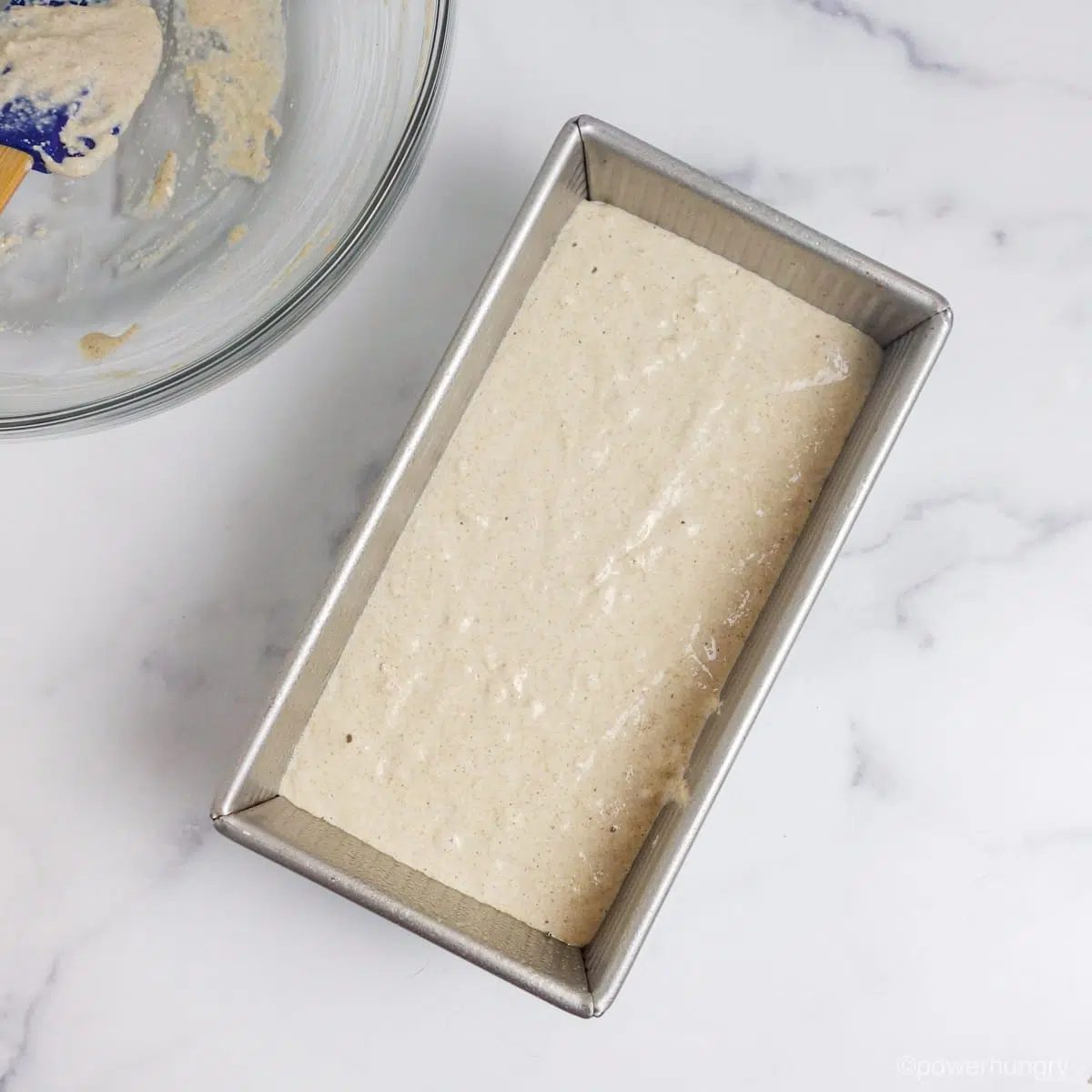 oat bread batter in a metal baking pan