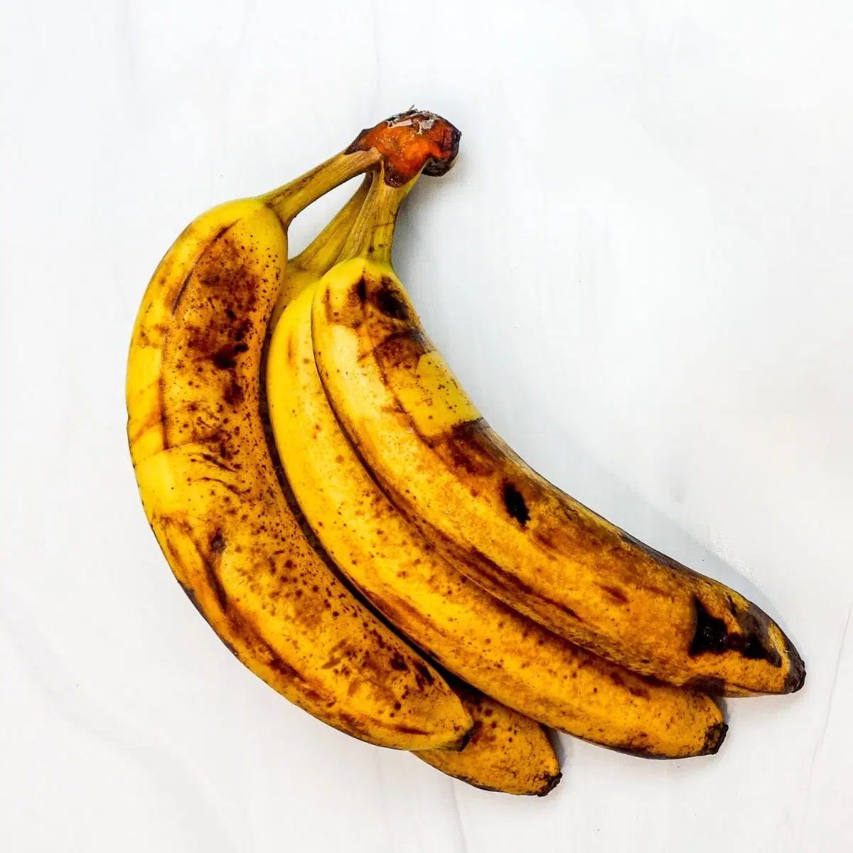 very ripe bananas on a marble surface