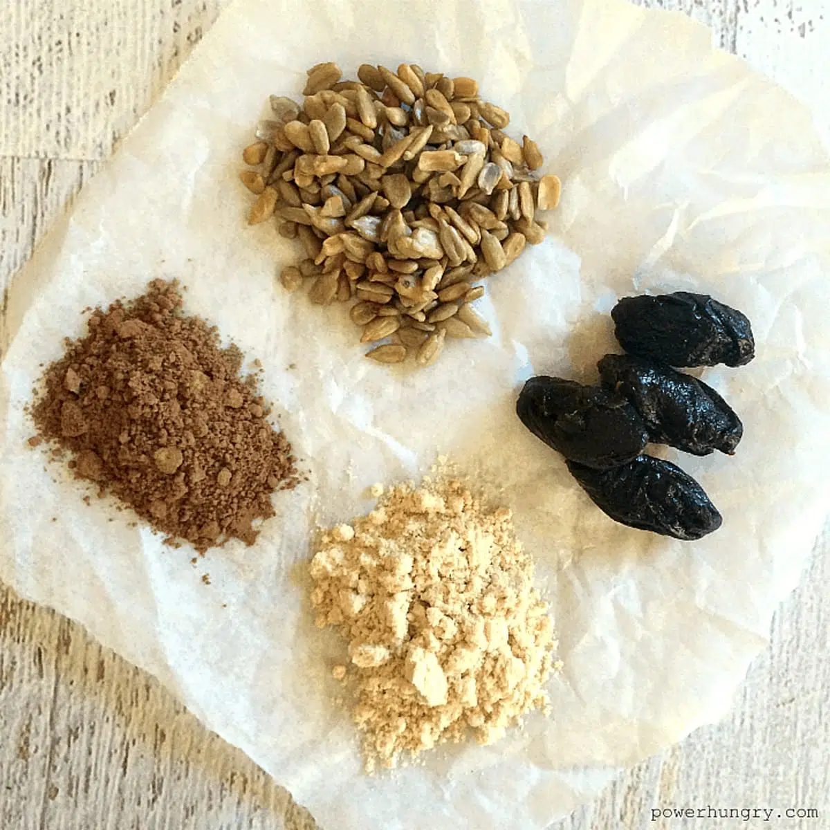 ingredients for sunflower seed chocolate bars on a piece of white parchment paper