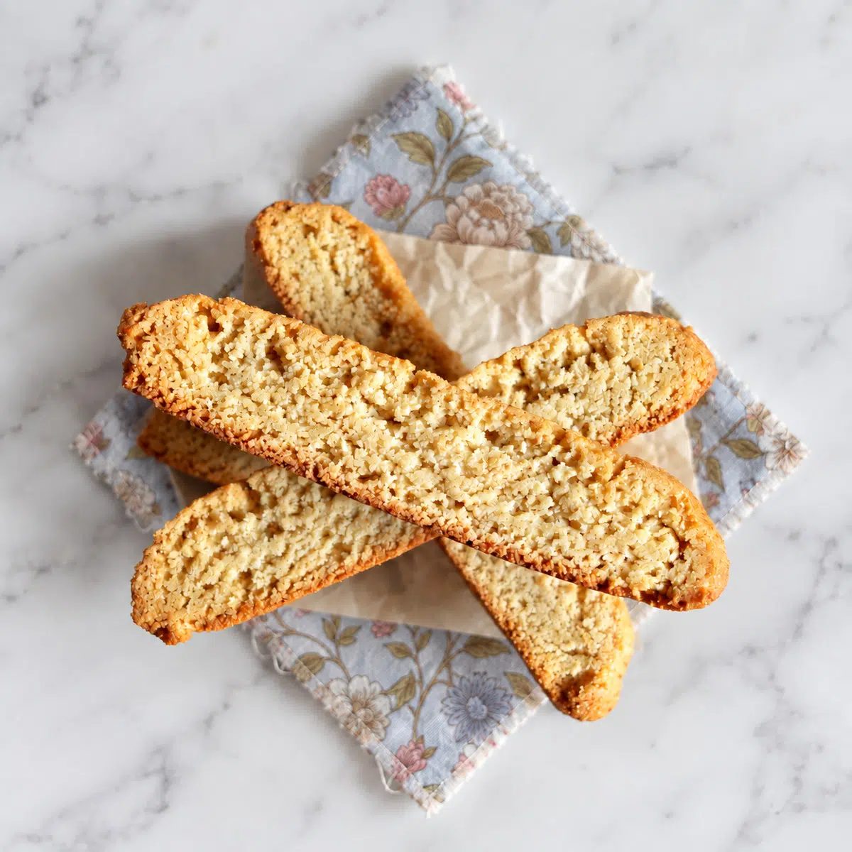 stack of vegan almond flour biscotti on a floral linen napkin